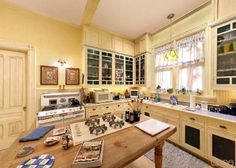 a kitchen with an oven, stove and table in it