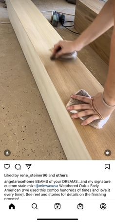 a woman is sanding the floor with her hand on top of a piece of wood