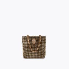 This Mini Party Tote Purse features a gold crystal exterior. There is a gold eagle head embellished with gold crystals sat on the front6.2in (H), 7in (L), 1.5in (D)Strap length: 12inTwo gold chain top handlesTextured interior liningPlease take extra care when styling this piece with delicate fabricsCan fit phones up to 7inchesMaterial: CrystalsStyle number: 3574861999 Formal Gold Bag With Gold-tone Logo Plaque, Luxury Evening Bag With Gold-tone Hardware For Party, Gold Luxury Evening Bag With Chain Strap, Gold Rectangular Bag With Gold-tone Logo Plaque, Party Bags With Gold-tone Logo Plaque, Luxury Gold Shoulder Bag For Party, Gold Embellished Evening Shoulder Bag, Glamorous Gold Embellished Shoulder Bag, Embellished Gold Evening Bag