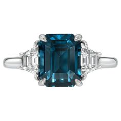 Unique and exotic 4.16 carat Ceylon Teal Sapphire Emerald-Cut, three stone platinum ring, flanked by a pair of 0.57 carat, D/VS2-SI1 Trapezoid diamonds. Ring size 6. Resizing is complementary upon request. The GIA gem report is attached to the image selection for your reference. Returns are accepted and paid by us within 7 days of delivery. Please FOLLOW the MERKABA storefront to be the first to view the latest of our ultra exclusive jewels and supreme gemstones. Merkaba Jewelry, is a unique, world-class jewelry brand, dedicated to unveiling the rarest, finest and most sought-after gemstones globally, such as Alexandrite, Paraiba Tourmaline, "no oil" Emeralds, unheated Sapphires and Rubies, Padparadscha Sapphire, Aquamarine, Tsavorite, Spinel, Mandarin Garnet, Chrome Tourmaline, Cat's Eye Luxury Three Stone Emerald Cut Sapphire Ring, Luxury Three-stone Emerald-cut Sapphire Ring, Luxury Emerald Three Stone Ring For Formal Occasions, Luxury Three Stone Emerald Ring, Formal Three Stone Sapphire Ring With Baguette Cut, Luxury Three Stone Asscher Cut Sapphire Ring, Three Stone Baguette Cut Sapphire Ring For Formal Occasions, Formal Three-stone Sapphire Ring With Baguette Cut, Luxury Three Stone Emerald Ring For Formal Occasions