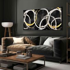 a modern living room with black walls and white art on the wall above the couch