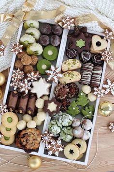 a box filled with lots of different types of cookies and pastries on top of a wooden table