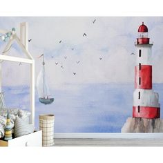 a bedroom scene with a bed and a wall mural that has a lighthouse on it