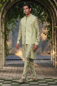 Mint green sleeveless Nehru jacket with stitchline thread embroidery in stripe pattern. Paired with floral print pleated kurta and churidar. - Aza Fashions Green Fitted Kurta With Stand Collar, Green Nehru Jacket With Stand Collar For Festive Occasions, Spring Wedding Green Bandhgala, Festive Green Nehru Jacket With Stand Collar, Traditional Green Nehru Jacket For Spring, Fitted Green Bandhgala For Spring, Spring Green Fitted Bandhgala, Fitted Green Nehru Jacket For Spring, Green Fitted Nehru Jacket For Spring