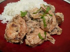 a red plate topped with rice and meat covered in gravy