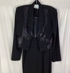 "Perceptions by Irene B- black glitter and  sequin jumpsuit and matching bolero jacket  Size-8 Tacked in removable shoulder pads  two self covered buttons on either side of the jacket   Comes with a belt with loops on the jumpsuit  Jumpsuit zips up the back- Jumpsuit- armpit to armpit--17\" has some horizontal stretch - goes to 19\" Jumpsuit inseam-31\" 100% poly Like new" Fitted Embellished Evening Pantsuit, Formal Fitted Sequin Pantsuit, Embellished Fitted Pantsuit For Formal Occasions, Fitted Sequin Pantsuit For Evening, Fitted Formal Pantsuit For Party Season, Fitted Pantsuit For Formal Party Season, Fitted Sequined Pantsuit With Long Sleeves, Fitted Long Sleeve Sequin Pantsuit, Formal Sequined Long Sleeve Pantsuit