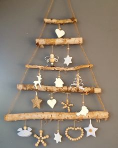 a christmas tree made out of branches with ornaments hanging from it's sides and stars on the top