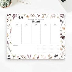 a desk calendar with flowers and plants on it