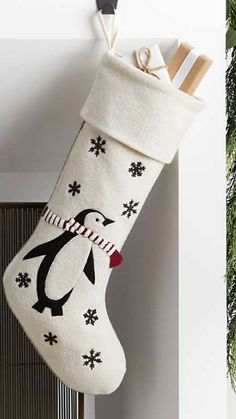 a penguin christmas stocking hanging on the wall