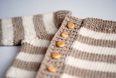 a close up of a sweater with buttons on it