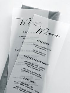 three menus with black and white lettering on them