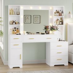 a white vanity with lights on it in a room next to a bed and window