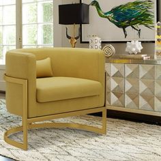 a yellow chair sitting in front of a window next to a table with a lamp on it