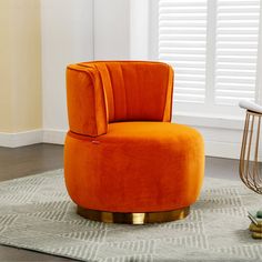 an orange chair sitting on top of a rug