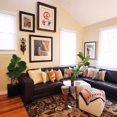 a living room filled with lots of furniture and decor on top of a hard wood floor