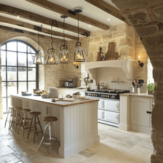 a kitchen with stone walls and an island in the middle, surrounded by stools