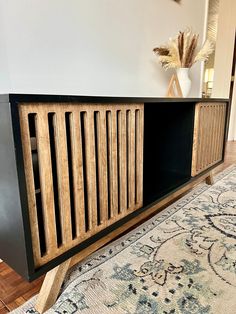 a large wooden cabinet sitting on top of a rug