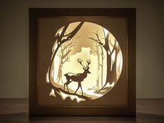 a paper cut deer in the middle of a forest