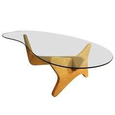 a glass and wood coffee table with an unusual design on the top, in front of a white background