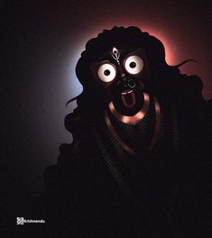 a creepy mask is lit up in the dark with its eyes wide open and tongue out