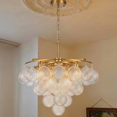 a chandelier hanging from the ceiling in a living room