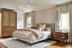 a bedroom with a bed and dressers in it