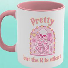 a pink and white coffee mug with a skeleton on it