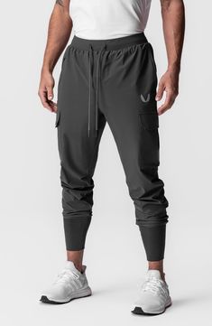 Built from extremely lightweight yet durable Tetra-Lite fabric, these joggers shed water and sport the comfort of four-way stretch. The high cuff ensures a secure fit that stays in place all day. 28 1/2" inseam; 7 1/2" leg opening; 12 1/2" front rise; 16 1/2" back rise (size Medium) Elastic/drawstring waist Front zip pocket; front slant pocket; cargo bellows flap-patch pockets; back zip phone pocket; shirt belt loop Four-way-stretch fabric Durable water-repellent (DWR) finish 76% nylon, 24% span Breathable Functional Cargo Pants For Outdoor, Stretch Techwear Joggers For Outdoor, Techwear Joggers With Side Pockets For Jogging, Urban Joggers With Cargo Pockets For Sports, Functional Moisture-wicking Midweight Joggers, Functional Midweight Moisture-wicking Joggers, Techwear Moisture-wicking Cargo Pants For Sports, Urban Sports Joggers With Side Pockets, Urban Sport Joggers With Side Pockets