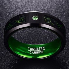 a green ring with the words tungten cardide engraved on it's side