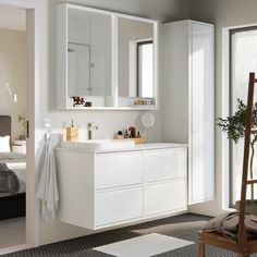 a white bathroom with two sinks and mirrors