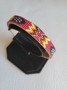 "I use size 15 seed beads. The length is 6\" and the width is 3/8\".Product is an adjustable cuff bracelet with a pigskin covering." Adjustable Beaded Cuff Bracelet Bangle, Adjustable Multicolor Beaded Leather Bracelet, Adjustable Beaded Cuff Bangle, Adjustable Beaded Wristlet, Adjustable Leather Bracelet With Colorful Round Beads, Adjustable Leather Bracelet With Colorful Beads, Traditional Adjustable Cuff Bracelet With Colorful Beads, Adjustable Traditional Cuff Bracelet With Colorful Beads, Southwestern Adjustable Beaded Bracelets