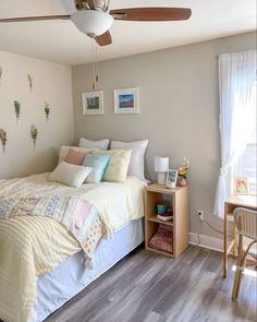 a bed sitting in a bedroom next to a wooden table and chair on top of a hard wood floor