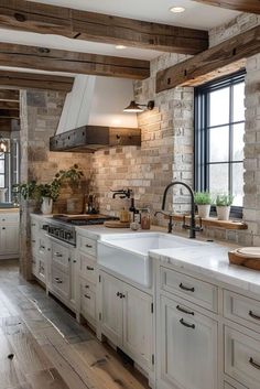 a large kitchen with white cabinets and wooden beams on the ceiling is decorated in rustic style