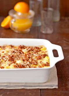 a casserole dish with oranges in the background