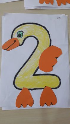 the paper is cut out to look like a number two with an orange duck on it