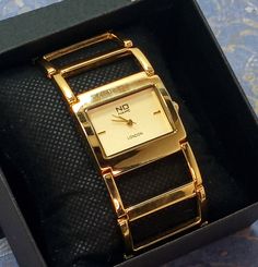 Vintage Women's Watch Gold Tone Open Link Dress Watch  Working! *Battery Operated Beautiful vibrant, shiny gold tone,open work articulated links cuff bracelet watch This watch is No Name London, I could find no information on this brand. It is in excellent condition and keeps good time.  I am guessing age to be from 90's by style/design. *Face: Champagne Rectangular *Indices: Gold stick @ 3 & 9 *Hands: Gold Baton  Hour, Minute, second *Fold over hinged clasp *Stainless steel case back *Face meas Gold Metal Watch Accessories With Metal Dial, Gold Watches With Bracelet Strap For Evening, Gold Metal Watch For Formal Occasions, Gold Metal Evening Watches, Formal Gold Metal Watch, Evening Gold Metal Watch, Gold Watch Accessories With Rectangular Dial For Evening, Gold Analog Watch For Evening, Gold Watch Accessories With Metal Dial For Evening