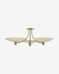 three light brass chandelier with white glass shades on the bottom and gold accents