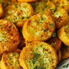 a white plate topped with fried potatoes covered in parsley