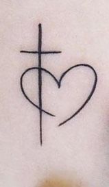 a cross and heart tattoo on the stomach