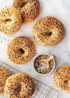 sesame seed bagels on a cooling rack with dipping sauce