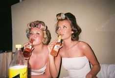 two women in bathing suits drinking from bottles