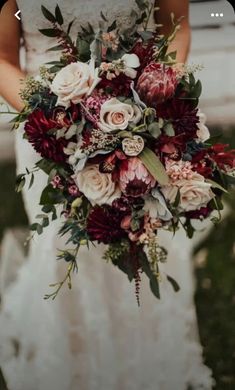 a woman holding a bouquet of flowers in her hands