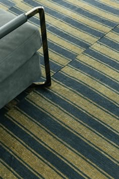 a couch sitting on top of a carpet covered floor