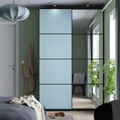 a bedroom with green walls and white sliding doors