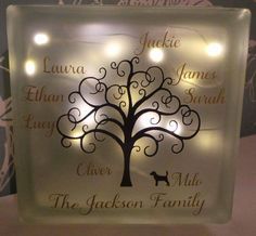 a lighted glass block with a family tree on it