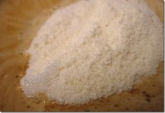 a bowl filled with white powder on top of a wooden table