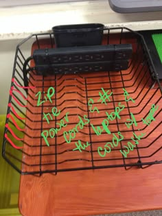 there is a wire rack with writing on it