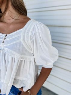 This off white top is calling your name! It has the cutest ruffle and raw edge detailing, which gives the perfect mix of distressed and chic! It even has an adorable button detail up the front! Pair this with some bellbottom jeans and boots for the perfect look! Wear it out with the girls or on a date night! Model is 5'7" wearing a small, making this true to size. 100% Cotton GENERAL SIZE CHART: 00-EXTRA SMALL, 0-2 SMALL, 4-6 MEDIUM, 8-10 LARGE, 12-14 EXTRA LARGE Each item runs differently there Flowy Summer Tops, Jeans And White Shirt, Flowy Tops Summer, Summer Street Style, Now Or Never, Summer Street, Street Style Summer, Senior Photos, Senior Year