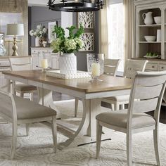 a dining room table with chairs around it