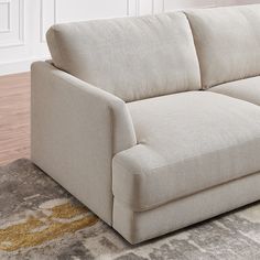 a white couch sitting on top of a rug